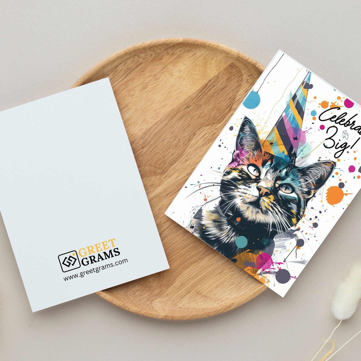 Happy birthday card showing cat wearing  birthday cap