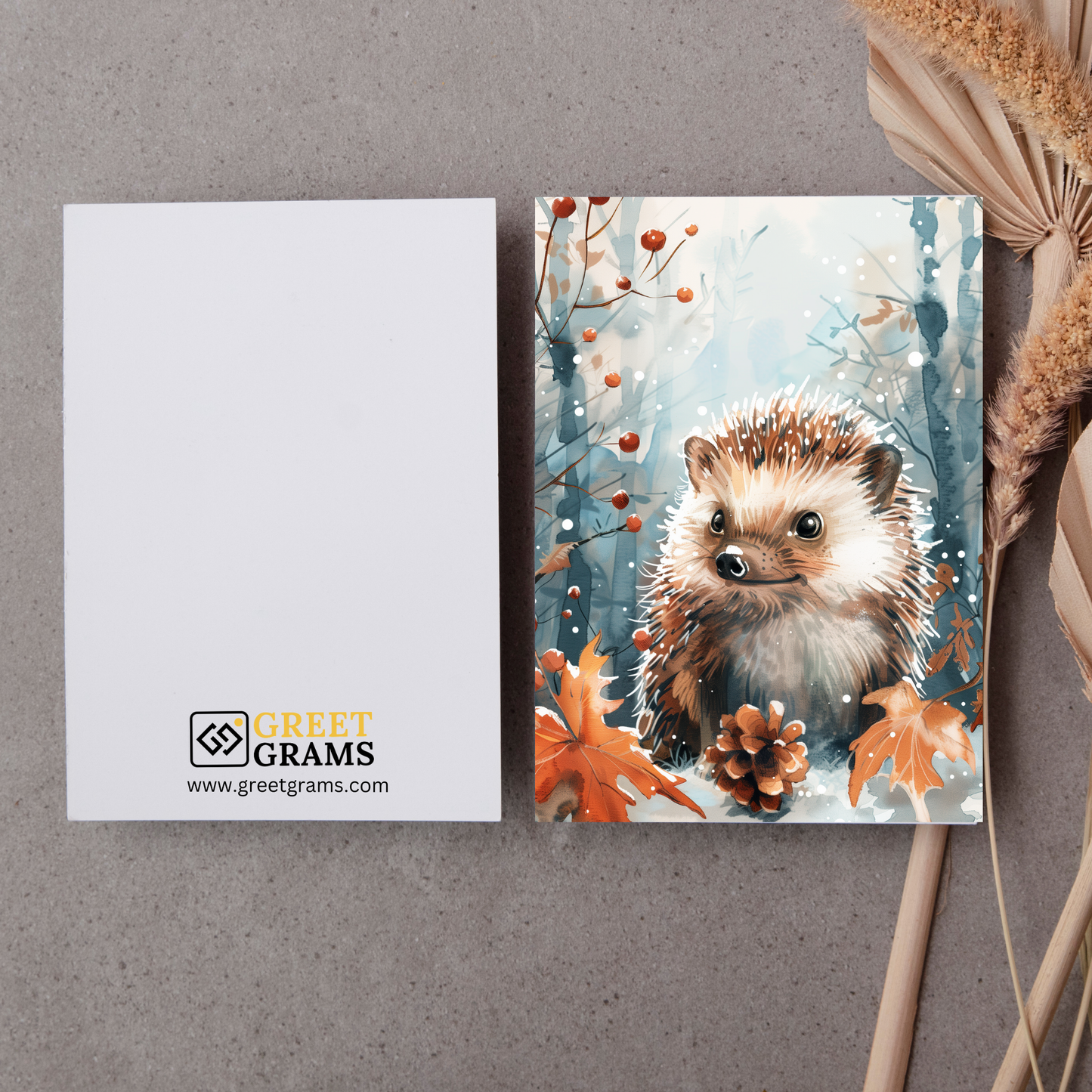 greeting card of a hedgehog surrounded by snow in the grey background