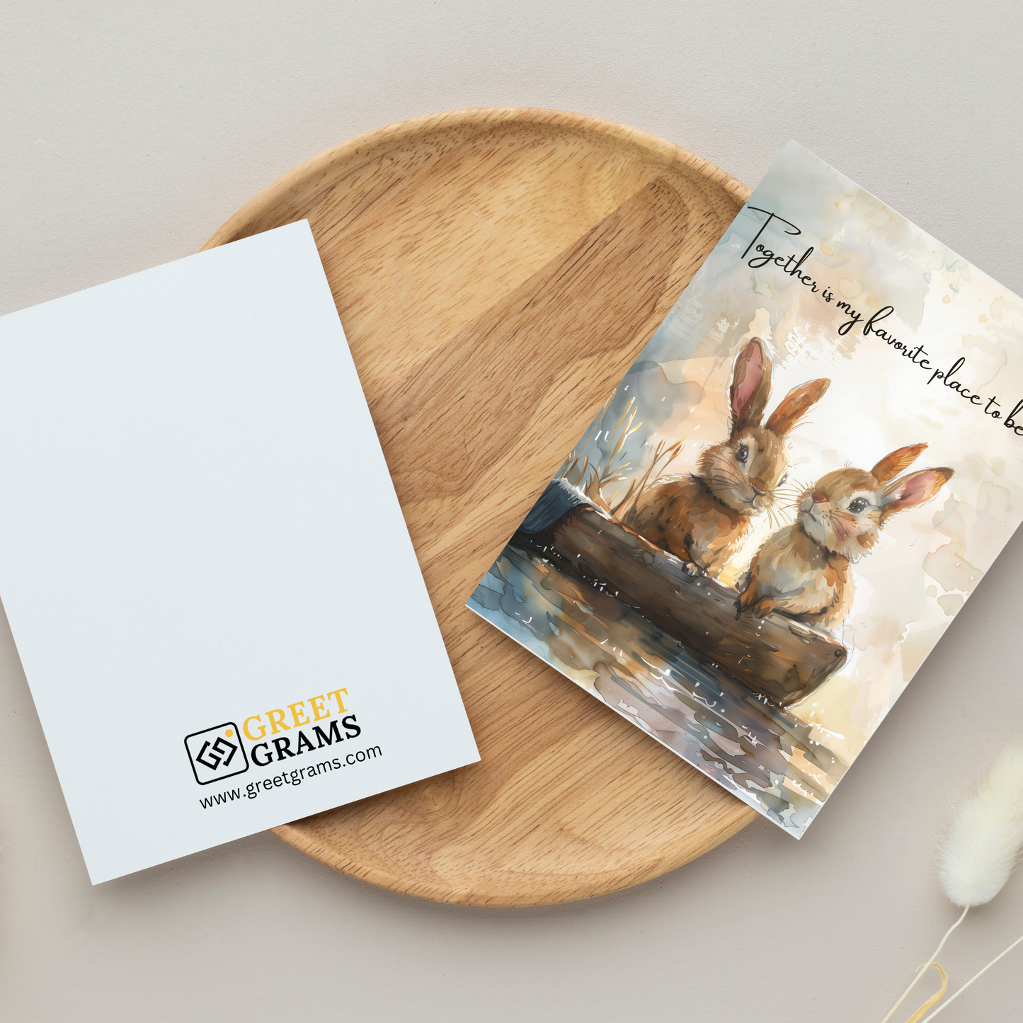 greeting card of a bunny couple on a boat in the gray background