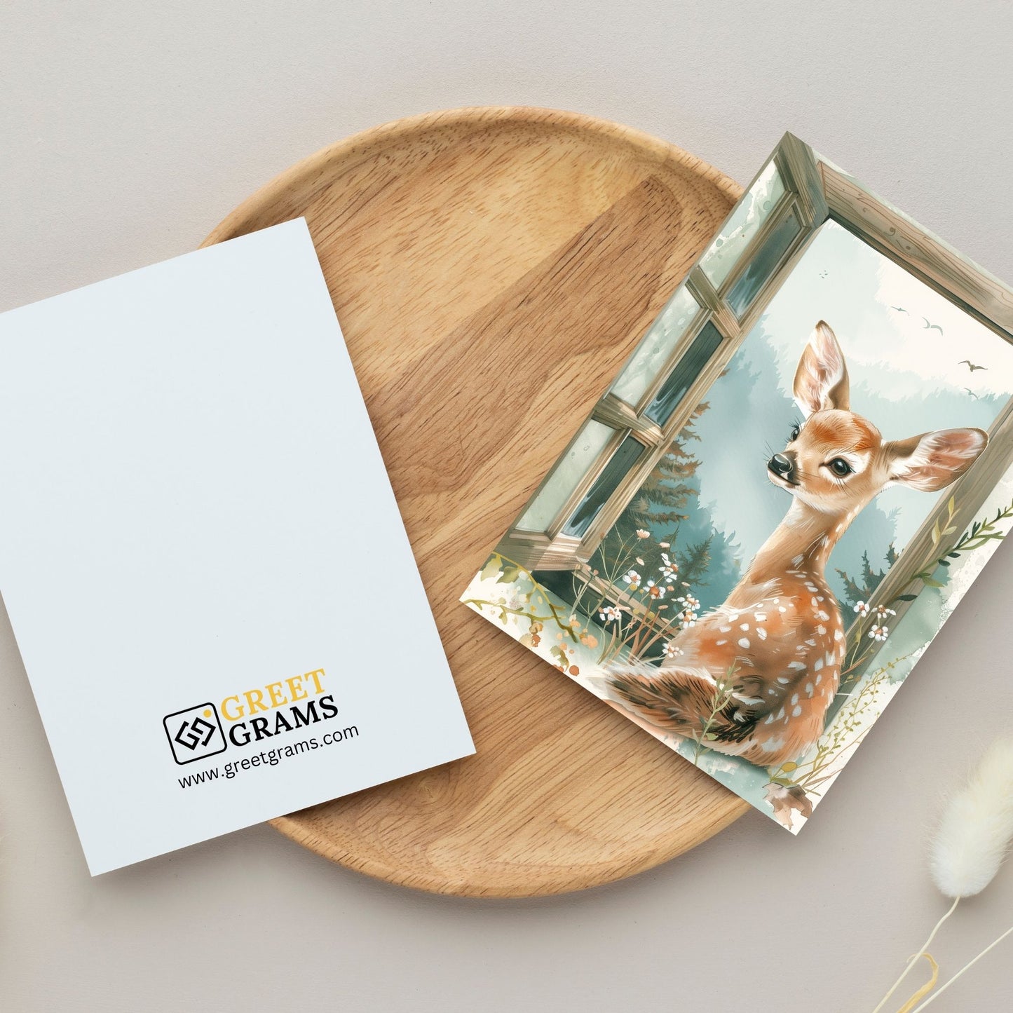 greeting card of a deer enjoying  at seaside escape in the grey background