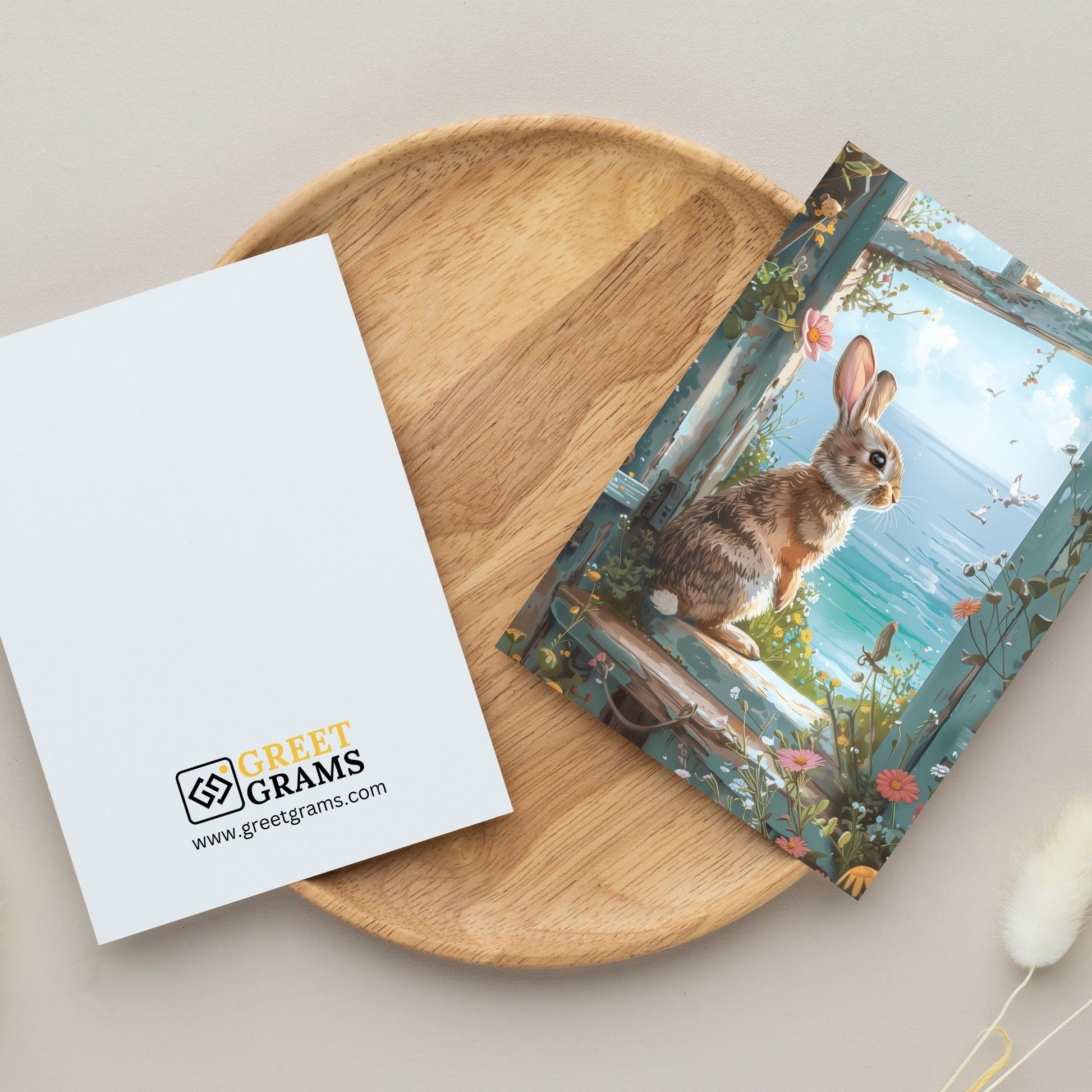 greeting card of a rabbit enjoying a peaceful retreat by the seaside in the grey background