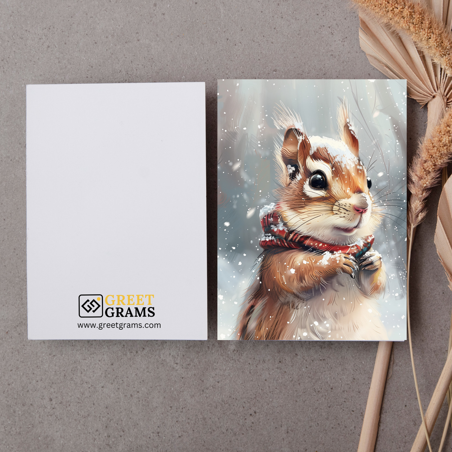 greeting card of a  chipmunk frolicking in the snow in the grey background